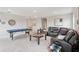 Spacious living area with a pool table, comfortable seating, and a relaxing atmosphere at 13055 Willow Grove Dr, Riverview, FL 33579
