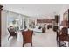 Spacious living room featuring tile floors, open layout, dark wood cabinets, and sliding glass doors at 13055 Willow Grove Dr, Riverview, FL 33579