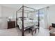 Comfortable primary bedroom with a four poster bed, neutral decor, and natural light at 13055 Willow Grove Dr, Riverview, FL 33579