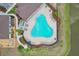 Aerial view of a community pool with lounge chairs and tables surrounded by well-maintained landscaping and a nearby spa at 13055 Willow Grove Dr, Riverview, FL 33579