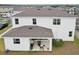 Backyard view of the home with a covered patio, outdoor grill, and well-maintained landscaping at 13055 Willow Grove Dr, Riverview, FL 33579