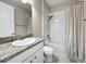 Bathroom featuring a single vanity with granite countertop and a shower-tub combo with a shower curtain at 13130 Monach Isles Dr, Riverview, FL 33579