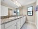 Bathroom featuring a large double vanity with granite countertop and a large mirror at 13130 Monach Isles Dr, Riverview, FL 33579