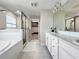 Modern bathroom with glass shower, soaking tub, and double vanity with marble countertop at 13130 Monach Isles Dr, Riverview, FL 33579