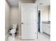 Half-bath with toilet and small sink with a granite countertop at 13130 Monach Isles Dr, Riverview, FL 33579