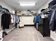 Spacious walk-in closet with ample shelving and storage, plus a small chair and black dresser at 13130 Monach Isles Dr, Riverview, FL 33579