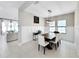 Bright dining room featuring a modern light fixture, neutral walls, and stylish decor at 13130 Monach Isles Dr, Riverview, FL 33579
