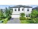 Charming two-story home featuring a well-maintained lawn, manicured landscaping, and a spacious two-car garage at 13130 Monach Isles Dr, Riverview, FL 33579