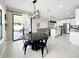 Bright kitchen with modern light fixtures and stainless steel appliances, with easy access to the backyard at 13130 Monach Isles Dr, Riverview, FL 33579