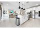 Open-concept kitchen featuring a center island with bar seating, stainless steel appliances, and seamless flow to the living room at 13130 Monach Isles Dr, Riverview, FL 33579