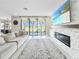 Cozy living room featuring a fireplace, large windows, and stylish furnishings at 13130 Monach Isles Dr, Riverview, FL 33579