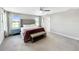 Comfortable main bedroom featuring a plush bed, bench, and ample natural light from the windows at 13130 Monach Isles Dr, Riverview, FL 33579
