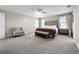 Serene main bedroom with natural light, plush bed, and neutral tones for a relaxing retreat at 13130 Monach Isles Dr, Riverview, FL 33579