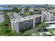 Exterior aerial view of the waterfront condo community featuring bay access, lush landscaping, and a serene fountain at 1316 Pasadena S Ave # 303, South Pasadena, FL 33707