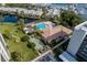 Community clubhouse aerial view featuring a swimming pool, shuffleboard courts, and well-maintained grounds at 1316 Pasadena S Ave # 303, South Pasadena, FL 33707