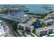 Scenic aerial view of condo complex and marina featuring waterfront views, easy boat access, and manicured grounds at 1316 Pasadena S Ave # 303, South Pasadena, FL 33707