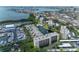 Aerial view of condo buildings and marina showcasing waterfront community with pool, canal, and easy access to the bay at 1316 Pasadena S Ave # 303, South Pasadena, FL 33707