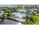 Aerial view showcasing the community pool, spa, and surrounding lush tropical landscaping at 1316 Pasadena S Ave # 303, South Pasadena, FL 33707