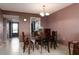 Inviting dining room featuring a wood table, four chairs, and a stylish chandelier at 1316 Pasadena S Ave # 303, South Pasadena, FL 33707