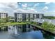Exterior photo of the waterfront condo building showcasing scenic water views, walking paths, and lush landscaping at 1316 Pasadena S Ave # 303, South Pasadena, FL 33707