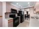 Efficient kitchen design with modern black appliances, functional layout, and adjacent dining area at 1316 Pasadena S Ave # 303, South Pasadena, FL 33707