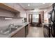 Efficient kitchen with stainless steel appliances and a cozy breakfast nook by the window at 1316 Pasadena S Ave # 303, South Pasadena, FL 33707