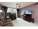 Cozy living room with plush seating, TV, and balcony access with beautiful view at 1316 Pasadena S Ave # 303, South Pasadena, FL 33707