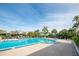 Large community pool surrounded by lounge chairs and palm trees at 1316 Pasadena S Ave # 303, South Pasadena, FL 33707
