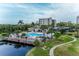 Community pool featuring lounge chairs, tables, and umbrellas perfect for relaxing and enjoying the waterfront view at 1316 Pasadena S Ave # 303, South Pasadena, FL 33707