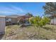 The backyard features a lush lawn, a garden area, and pergola at 13308 Prestwick Dr, Riverview, FL 33579