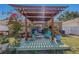 Charming backyard deck with pergola, hanging plants, and cozy seating area, perfect for outdoor relaxation at 13308 Prestwick Dr, Riverview, FL 33579