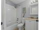 This bathroom features a shower and tub combo with a white vanity and shower curtain at 13308 Prestwick Dr, Riverview, FL 33579