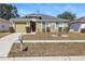 Charming single-story home featuring a well-maintained lawn and a cozy, inviting entrance at 13308 Prestwick Dr, Riverview, FL 33579