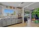 Well-lit kitchen with stainless steel appliances, light gray cabinets, and an open view to the living area at 13308 Prestwick Dr, Riverview, FL 33579