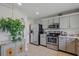 Modern kitchen featuring stainless steel appliances, gray cabinets, and a convenient layout at 13308 Prestwick Dr, Riverview, FL 33579