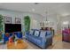 Cozy living room featuring a blue sofa, modern decor, and ample natural light at 13308 Prestwick Dr, Riverview, FL 33579