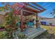 Backyard pergola with outdoor seating and beautiful flowering vines at 13308 Prestwick Dr, Riverview, FL 33579