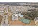 Aerial view of community amenities including tennis courts, pool, clubhouse, parking and green spaces at 13311 Orca Sound Dr, Riverview, FL 33579