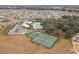 Aerial view of the community featuring a pool, tennis courts, parking, clubhouse and green spaces at 13311 Orca Sound Dr, Riverview, FL 33579