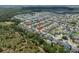 An aerial view of the neighborhood showcasing lush greenery, nearby lake and neatly arranged homes at 13311 Orca Sound Dr, Riverview, FL 33579