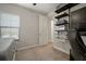 Neutral bedroom with desk, shelving, carpet flooring, and window at 13311 Orca Sound Dr, Riverview, FL 33579