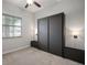 Cozy bedroom featuring a closed murphy bed with side tables and overhead lighting at 13311 Orca Sound Dr, Riverview, FL 33579