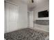 Bedroom featuring a murphy bed with wall-mounted TV and floating storage at 13311 Orca Sound Dr, Riverview, FL 33579