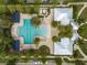 An aerial showcases the community pool area, highlighting lush landscaping, ample lounge seating, and nearby clubhouse at 13311 Orca Sound Dr, Riverview, FL 33579