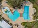 This aerial shot highlights the community pool and play area, featuring lounge chairs, well-maintained landscaping, and various amenities at 13311 Orca Sound Dr, Riverview, FL 33579