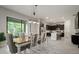Open-concept dining area adjacent to the kitchen with modern lighting and access to outdoor seating at 13311 Orca Sound Dr, Riverview, FL 33579