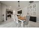 Dining room with decorative wall art, modern lighting fixture, and seamless flow to the kitchen at 13311 Orca Sound Dr, Riverview, FL 33579
