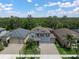 Charming two-story home with a well-manicured lawn, brick driveway, and lush landscaping at 13311 Orca Sound Dr, Riverview, FL 33579
