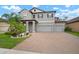 Charming two-story home featuring a three-car garage, brick paved driveway, and tropical landscaping at 13311 Orca Sound Dr, Riverview, FL 33579