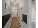 Bright hallway with modern lighting, stylish decor, and neutral tones with black chair railing at 13311 Orca Sound Dr, Riverview, FL 33579
